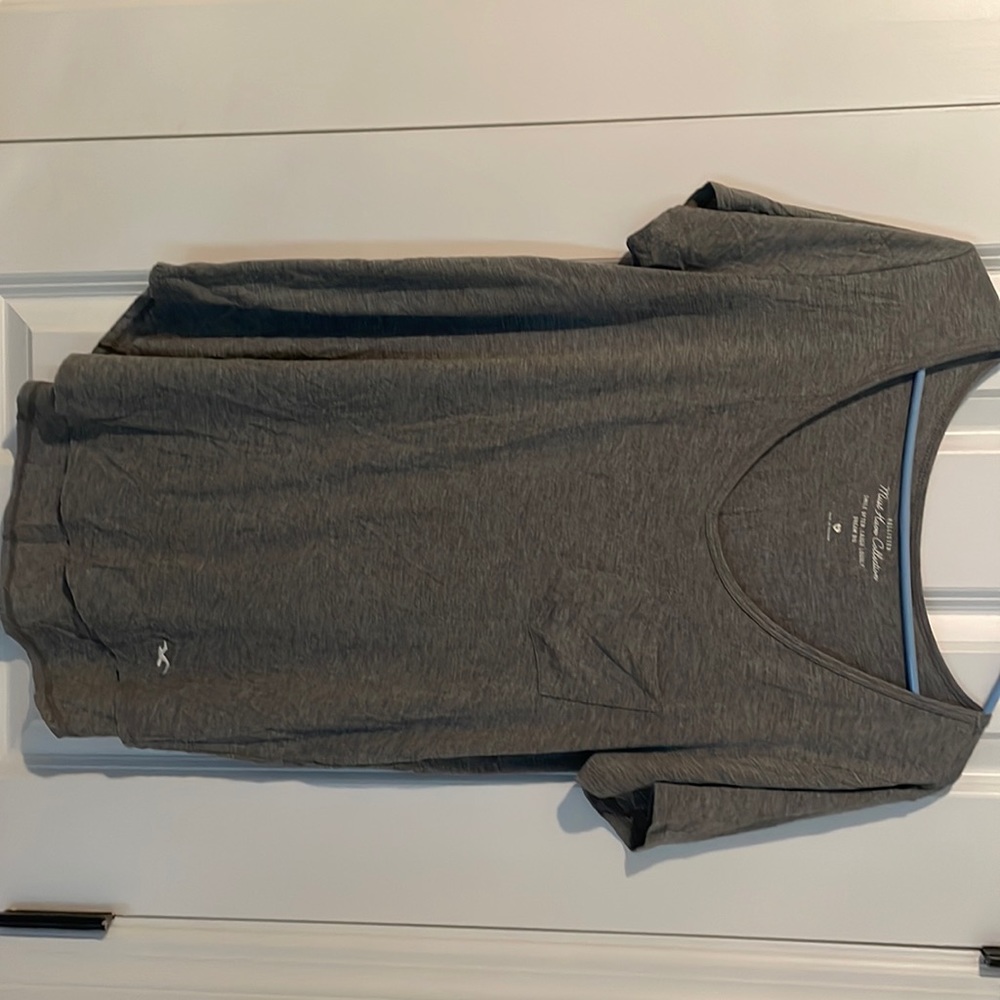 Grey Hollister short sleeve shirt with a front pocket! V neck line. Size medium